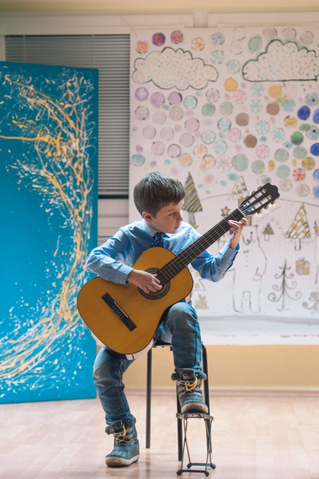 Young Jakub playing guitar